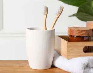 Toothbrushes in a ceramic cup